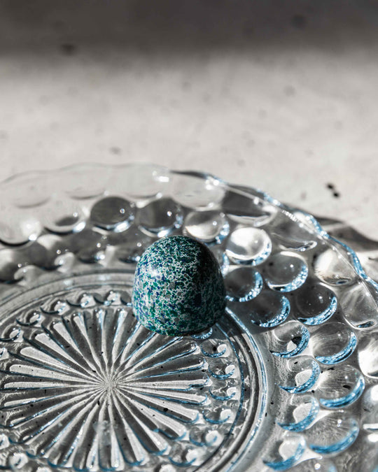 single bonbon on glass tray
