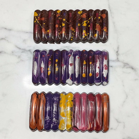 Set of three colorful chocolate bars on a marble table background. 